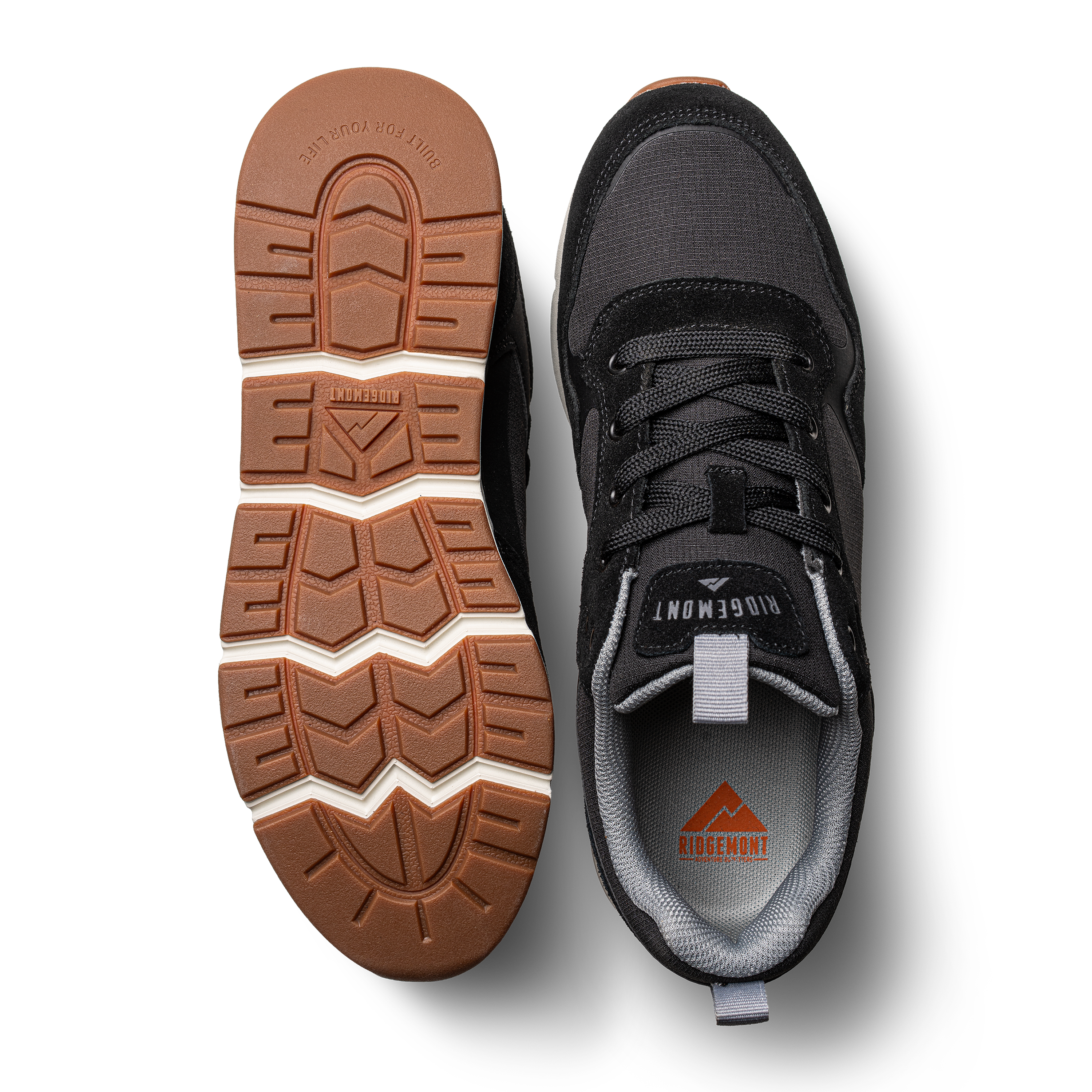 Pair of Ridgemont Escape sneaker shoe in color Black shows top and bottom of shoe. Left shoe shows real rubber tread in color gum and sturdy but comfortable sole. Right shoe shoes black micro ripstop poly, black laces, black canvas, black oil suede, grey inner lining, and black stitching. Outdoor shoes, everyday sneaker, comfort, everyday shoes.
