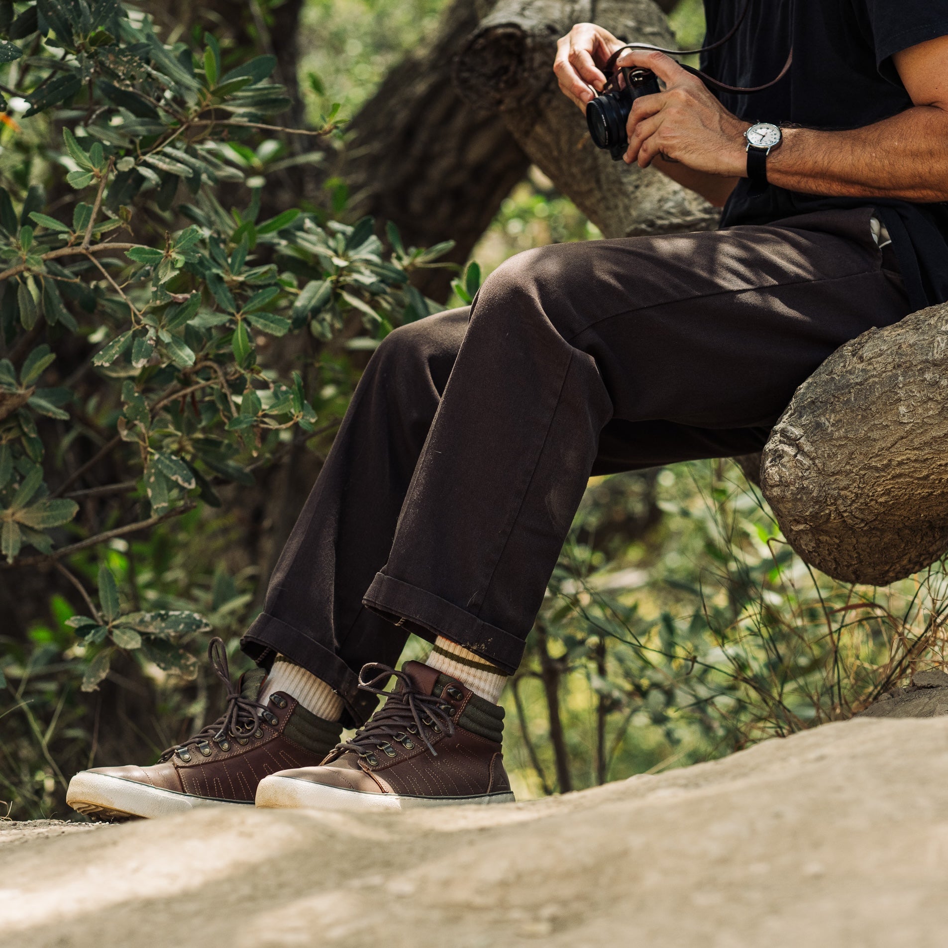Pair of Ridgemont Outback boots in colors Brown Olive being worn on beach, outside, outdoors, in sand, made for any activity. Shoes show brown laces, green waxed cotton canvas, cream off-white foxing, and lace hooks. Outdoor boot, outdoor boots, outdoor shoes, outdoor shoe. Ridgemont Outback photography in California.