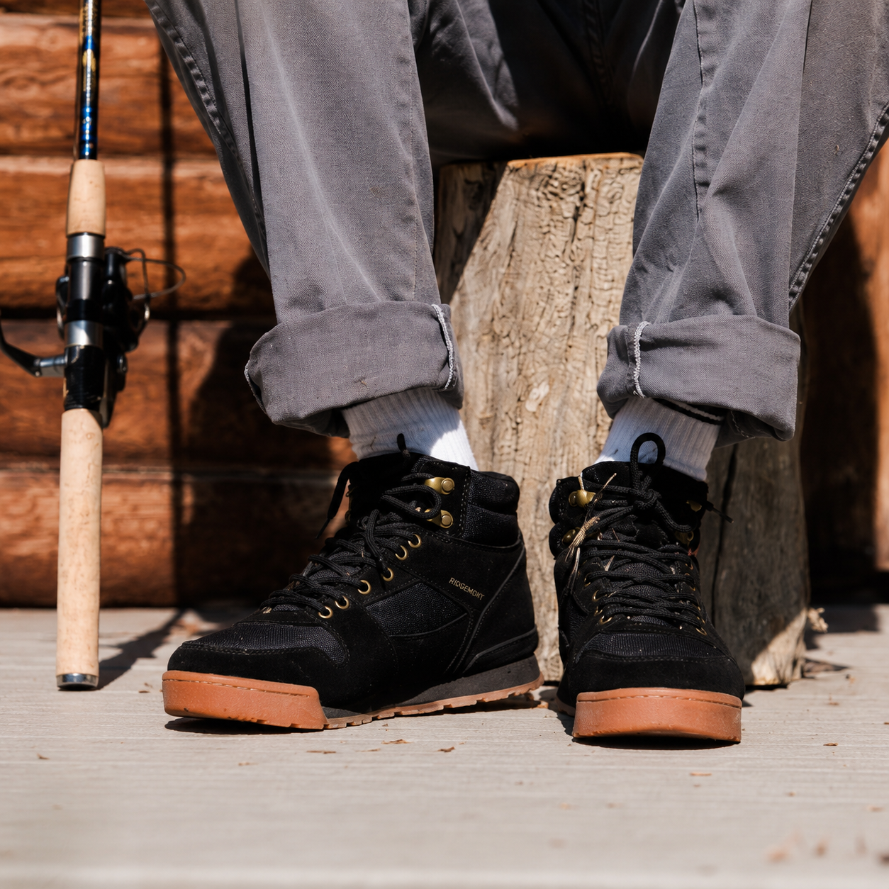 Fisherman wears Ridgemont Monty boot in Black Gum with Fishing pole sitting on stump