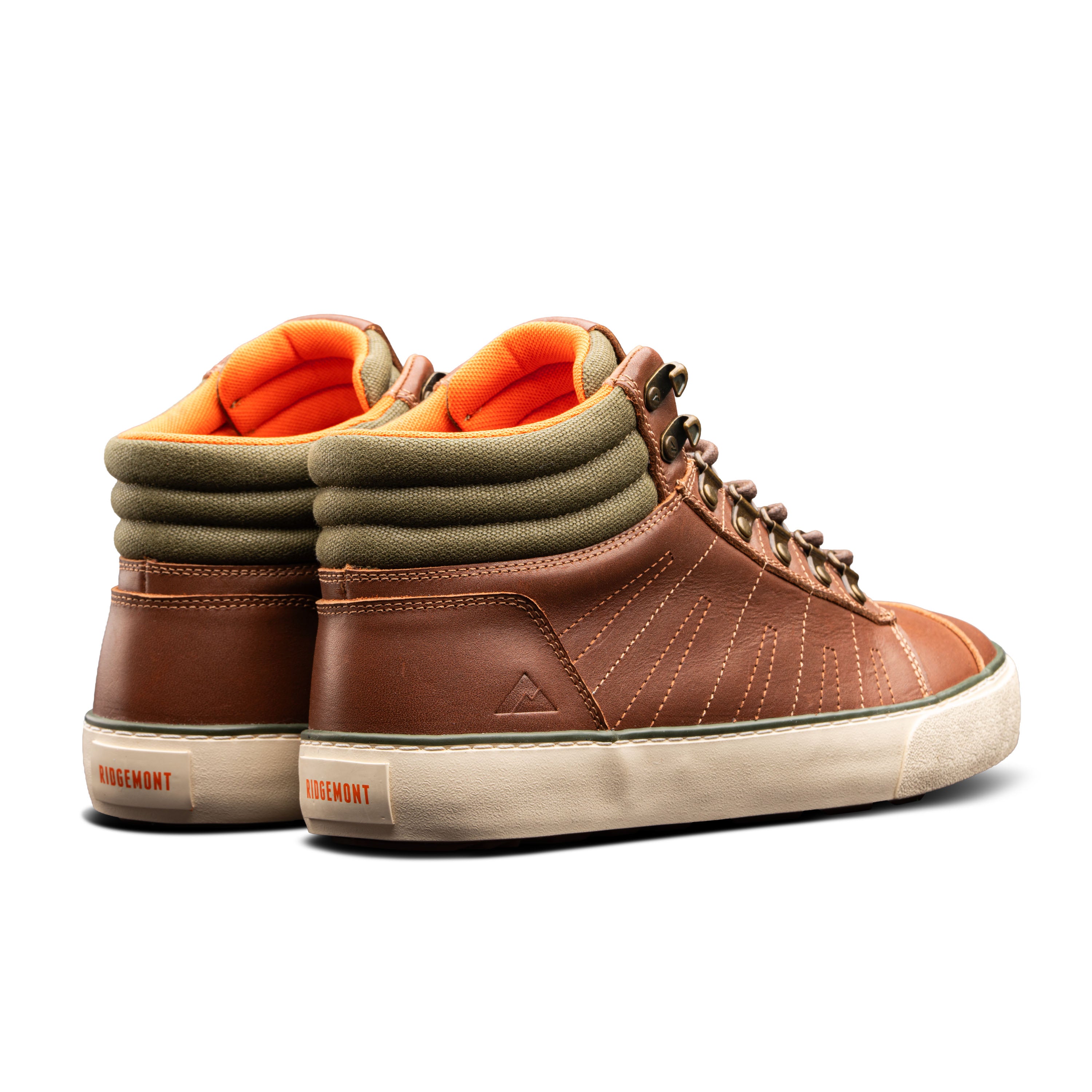 Pair of Ridgemont Outback boots in colors Brown Olive side heel cross view showing shoe full grain leather, green cotton canvas, cream (off-white) foxing, lace hooks, and orange inner lining. Outdoor boot, outdoor shoe.
