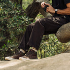 Pair of Ridgemont Outback boots in colors Brown Olive being worn on beach, outside, outdoors, in sand, made for any activity. Shoes show brown laces, green waxed cotton canvas, cream off-white foxing, and lace hooks. Outdoor boot, outdoor boots, outdoor shoes, outdoor shoe. Ridgemont Outback photography in California. 