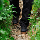 Surfer wearing Ridgemont Black Gum Monty walking down trail to beach